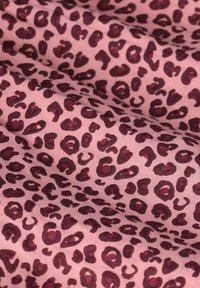 Cotton fabric featuring a pink background with dark burgundy leopard print spots. Smooth texture, with irregular patterns throughout.