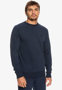 Navy blue sweatshirt in cotton-blend fabric with ribbed cuffs and hem. Features a small logo on the chest and a classic crew neck design.