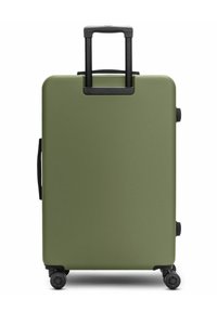 Valigia rigida di colore verde oliva con finitura opaca, manico estensibile nero e quattro ruote nere per la mobilità.