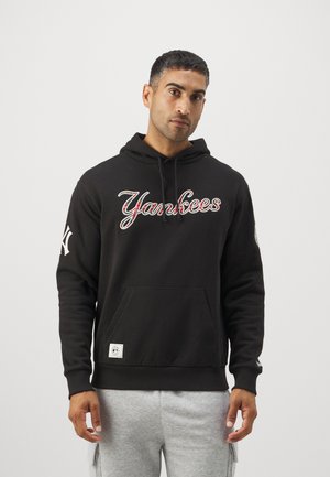Black hoodie with "Yankees" in multi-colored lettering, kangaroo pocket, ribbed cuffs, and a logo accent on the sleeve.