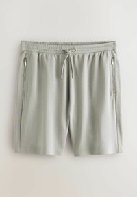 Lysegrå shorts lavet af blødt stof, med elastisk talje og snøre. To lynlåslommer på siden og glatte kanter.