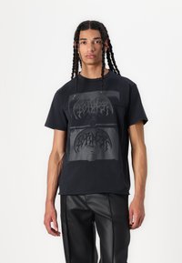 Black cotton t-shirt featuring a graphic print in grey tones, round neckline, short sleeves, and a relaxed fit.