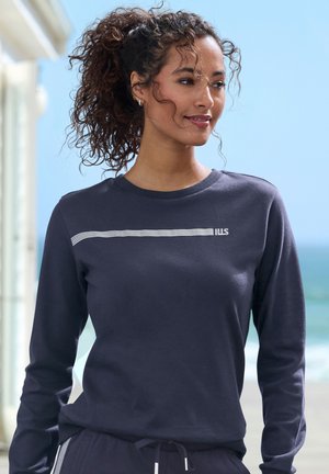 Navy long-sleeve sweatshirt made from soft fabric, featuring a white striped accent and a small logo on the chest. Smooth texture.