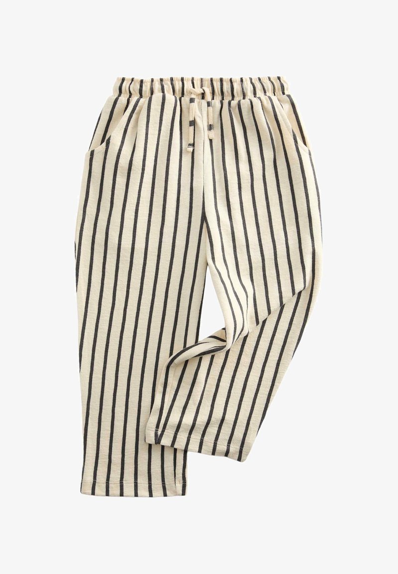 Beige broek met zwarte verticale strepen, elastische tailleband met trekkoord en zijzakken, plat neergelegd met één been licht gebogen.