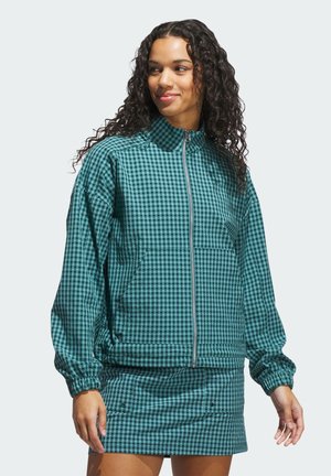 Grön och svart rutig zip-up jacka med hög krage, elastiska ärmmuddar och framfickor; matchad med en tillhörande mini kjol.