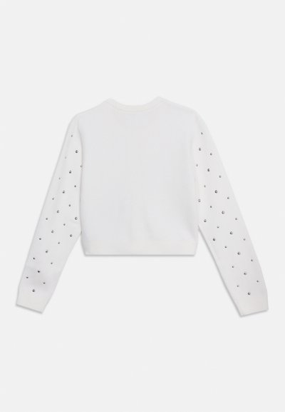 Valge pika varrukaga lühike kampsun ümarate kaelusega ja hõbedaste naeltega, mis on ühtlaselt jaotatud mõlemal varrukal.