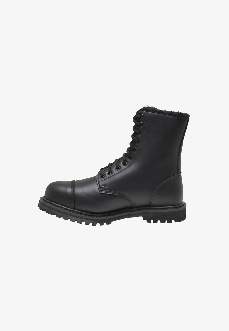 Bottines noires en cuir avec lacets, dotées d'une semelle en caoutchouc robuste, d'une doublure en fourrure sur le haut et d'un renfort à l'orteil pour plus de durabilité.