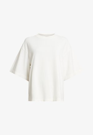 T-shirt bianca oversize con maniche corte e larghe. Realizzata in morbido cotone, presenta un collo rotondo e una vestibilità rilassata. Senza loghi visibili.