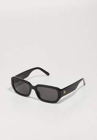 Black rectangular sunglasses with dark lenses, featuring a glossy finish, thick frames, and a small gold logo accent on the side.