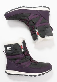 Schwarze und lila wasserdichte Winterstiefel mit Kunstfellbesatz, ausgestattet mit überkreuzten Riemen und einer strukturierten Gummisohle. Markenlogo an der Seite sichtbar.