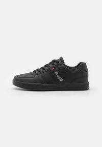 Black athletic sneaker with a smooth leather upper, round toe, contrasting white stitching, and a textured rubber sole. Features lace-up design.