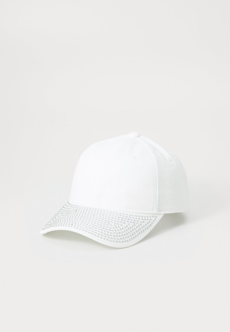 White baseball cap with a textured silver rhinestone- embellished brim, featuring six ventilation eyelets and a rounded crown.