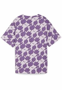 Short-sleeved t-shirt in light lavender, featuring a repeating purple floral pattern. Material is soft with a relaxed fit. Branding is visible.