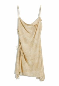 Beige slip dress with thin straps, a draped neckline, and asymmetric hem. Features a tie detail on one side and a soft, textured fabric.