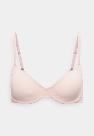 Soutien-gorge à armatures rose clair avec bretelles réglables, bonnets moulés lisses et logo Calvin Klein embossé sur les bretelles.
