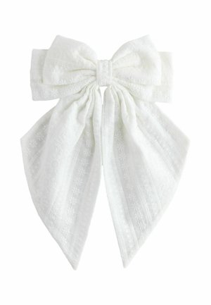 White fabric bow with textured floral and striped patterns, featuring two long tails and a gathered center knot.