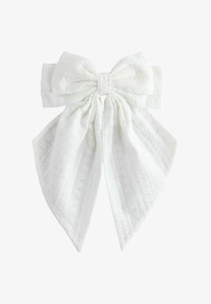 White fabric bow with textured floral and striped patterns, featuring two long tails and a gathered center knot.
