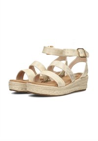 Beige espadrille sandals with wide cross straps, textured fabric, ankle buckle, and 5 cm woven jute wedge sole.