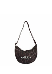 Czarna i brązowa torba na ramię w zwierzęcy wzór z motywem lamparta, o zakrzywionym kształcie, z zamkiem błyskawicznym i białym logo "adidas" na przodzie.