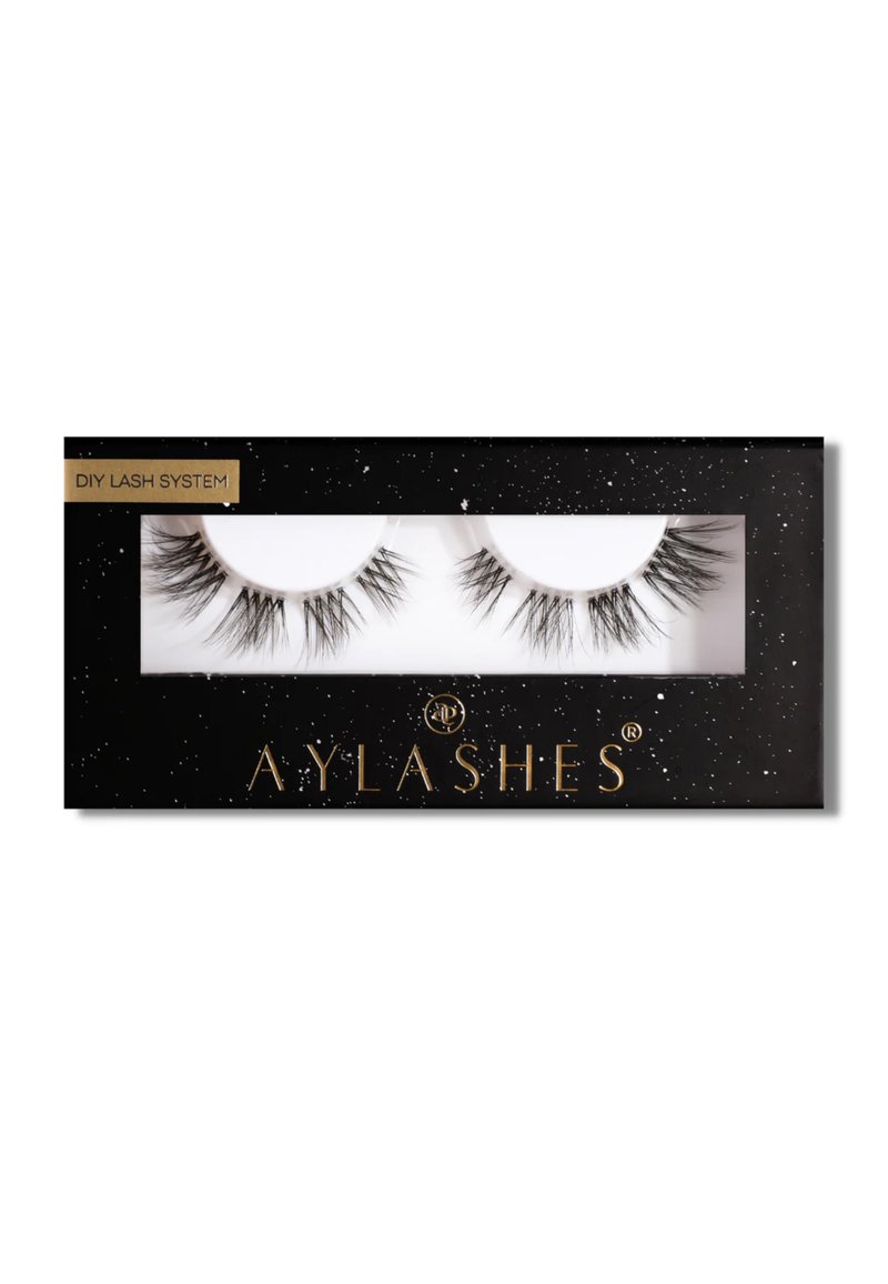 Black rectangular packaging with a transparent window, featuring two pairs of long black eyelashes. Text reads "DIY Lash System" and "AYLASHES."
