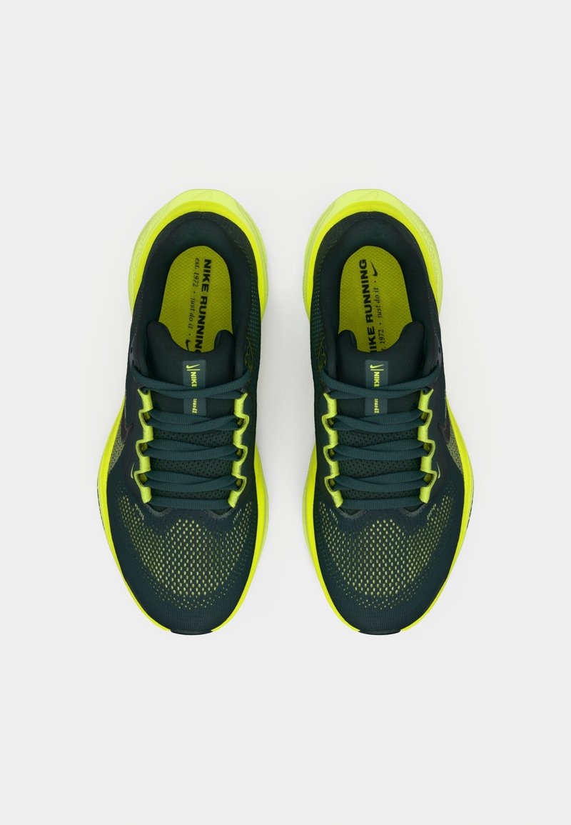 Un par de zapatillas de running Nike de color verde oscuro y amarillo neón vistas desde arriba sobre un fondo blanco.