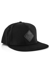Black snapback cap made of fabric, featuring a flat visor, diamond-shaped black patch with text, and tonal stitching. Minimalist design.