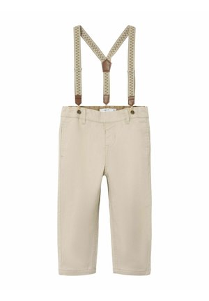 Pantaloni beige con bretelle removibili. Le bretelle presentano un design a motivo e accenti in pelle marrone. Dotati di tasche anteriori.