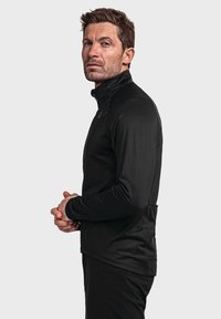 Schwarzes langärmeliges Sportoberteil mit hohem Kragen, aus einem glatten, dehnbaren Material; verfügt über einen Reißverschluss vorne und eine Tasche auf der Rückseite.