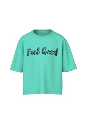 T-shirt surdimensionné à manches courtes couleur turquoise avec le texte « Feel Good » en lettres à motif floral sombre centré sur le devant.