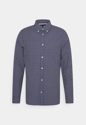 Camicia blu navy a maniche lunghe con bottoni, con piccolo motivo bianco a forma di foglia e colletto abbottonato.
