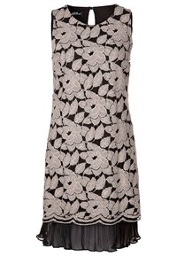 Svart ärmlös klänning med blommig spetsöverdrag, med en vågig fåll och plisserad nederdel. Detalj med nyckelhål i ryggen.