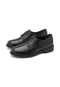 Scarpe in pelle nera con finitura liscia, punta rotonda, design con lacci e suola in gomma bassa e resistente. Cuciture a contrasto lungo i bordi.