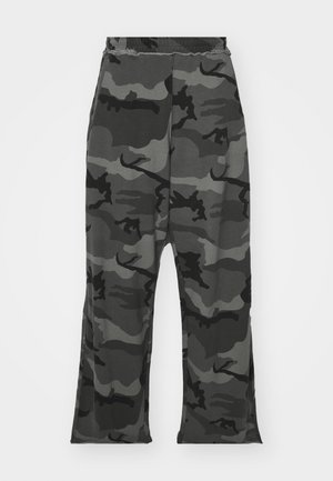 Pantalones de chándal de camuflaje en tonos de negro y gris, con cinturilla elástica, ajuste relajado y pequeñas aberturas en la parte inferior de las piernas.