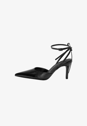 Black pointed-toe high heel shoe with a cut-out design and adjustable ankle strap. The shoe has a smooth, shiny surface and slender heel.