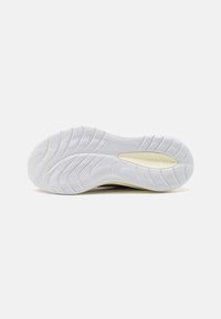 Suela de zapato con un diseño de goma blanca texturizada, con surcos y patrones para una mayor tracción y flexibilidad.