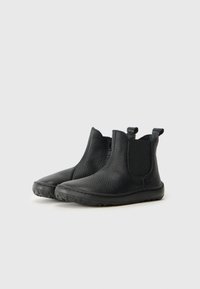 Black leather ankle boots with a textured finish, elastic side panels, and pull tabs for easy wear. Rubber sole for traction and durability.