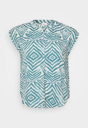 Bez piedurknēm, gaismas krēmkrāsas krekls ar teal ģeometriskiem rakstiem, ar apaļu kakla izgriezumu un piedurknēm pa priekšpusi, lai pievienotu tekstūru.