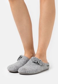 Gray felt slippers with rounded toes, featuring two decorative flower appliqués on the vamp and a gray rubber outsole.