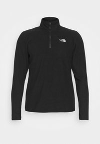 Pullover in pile nero con colletto alto e zip a un quarto. Presenta un piccolo logo bianco sul lato sinistro del petto. Maniche lunghe.