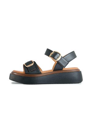 Black platform sandal with two adjustable gold buckle straps and thick sole, designed for casual wear.