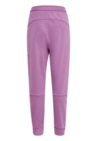 Lilla joggingbukser lavet af blødt stof, med en tætsiddende ankel-design, elastisk talje og sømløs konstruktion. Ingen synlige lommer.