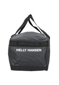 Czarna wodoodporna torba duffel z górnym zamkiem, mocny materiał, regulowane czarne paski i białym napisem "HELly HANSEN" z przodu.
