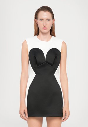 Fitted dress featuring a black bodice with a heart-shaped design, contrasting white sides, smooth texture, and a sleeveless cut.