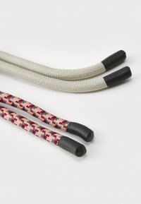 Two sets of shoelaces: one in a solid light grey braided material with black tips, the other in a multicolored pattern of red, pink, and black.
