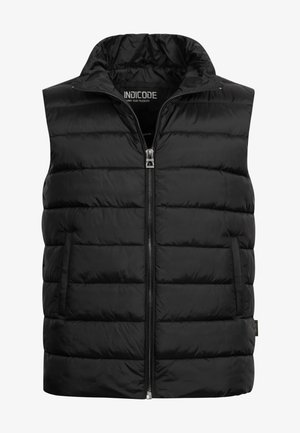 Schwarze gepolsterte Weste mit hohem Kragen, Reißverschluss und zwei Seitentaschen. Hergestellt aus glänzendem, leichtem Material mit gestepptem Muster.