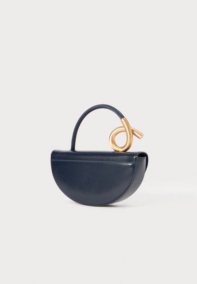 Navy leather handbag with a curved, half-moon shape; features a gold metal handle with a spiral design and a smooth, shiny texture.