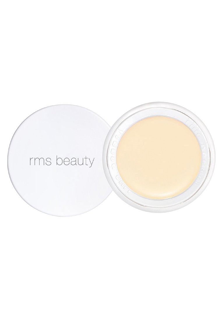 RMS Beauty-crème in een ronde, doorzichtige container met een witte deksel. Het product is een lichtgele crème, met een gladde textuur en zonder zichtbare patronen.