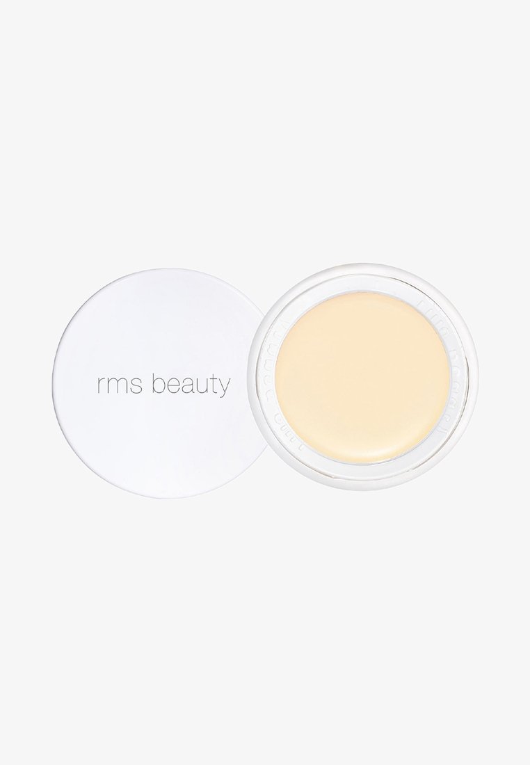 RMS Beauty Creme in einem runden, klaren Behälter mit einem weißen Deckel. Das Produkt ist eine blassgelbe Creme mit glatter Textur und ohne sichtbare Muster.