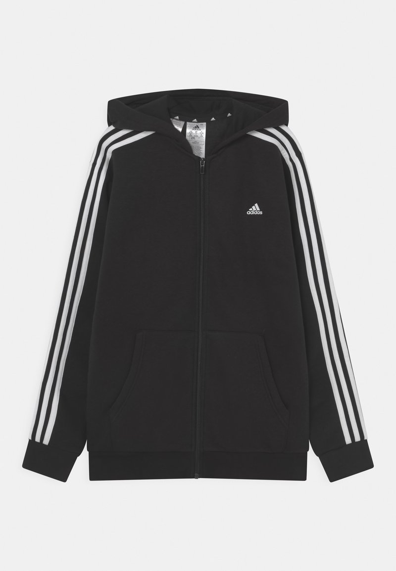 Felpa nera con zip realizzata in tessuto morbido, dotata di cappuccio, due tasche frontali e tre strisce bianche lungo le maniche. Logo Adidas sul petto.