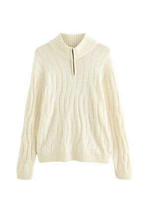 Cream-colored knitted sweater with cable knit design, ribbed collar, cuffs, and hem. Features a quarter-length zipper at the neck.